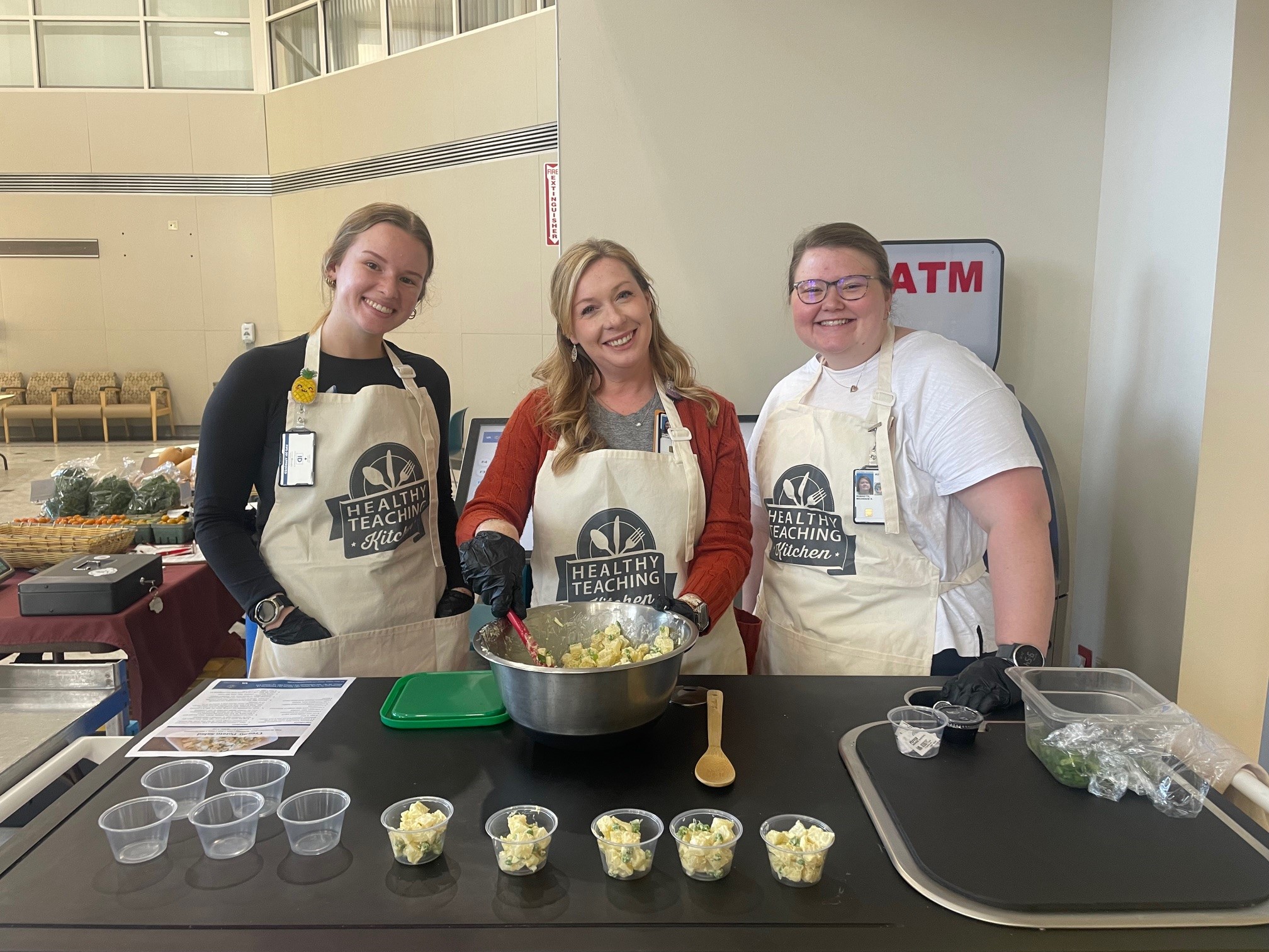 Three individuals hosting a cooking demonstration
