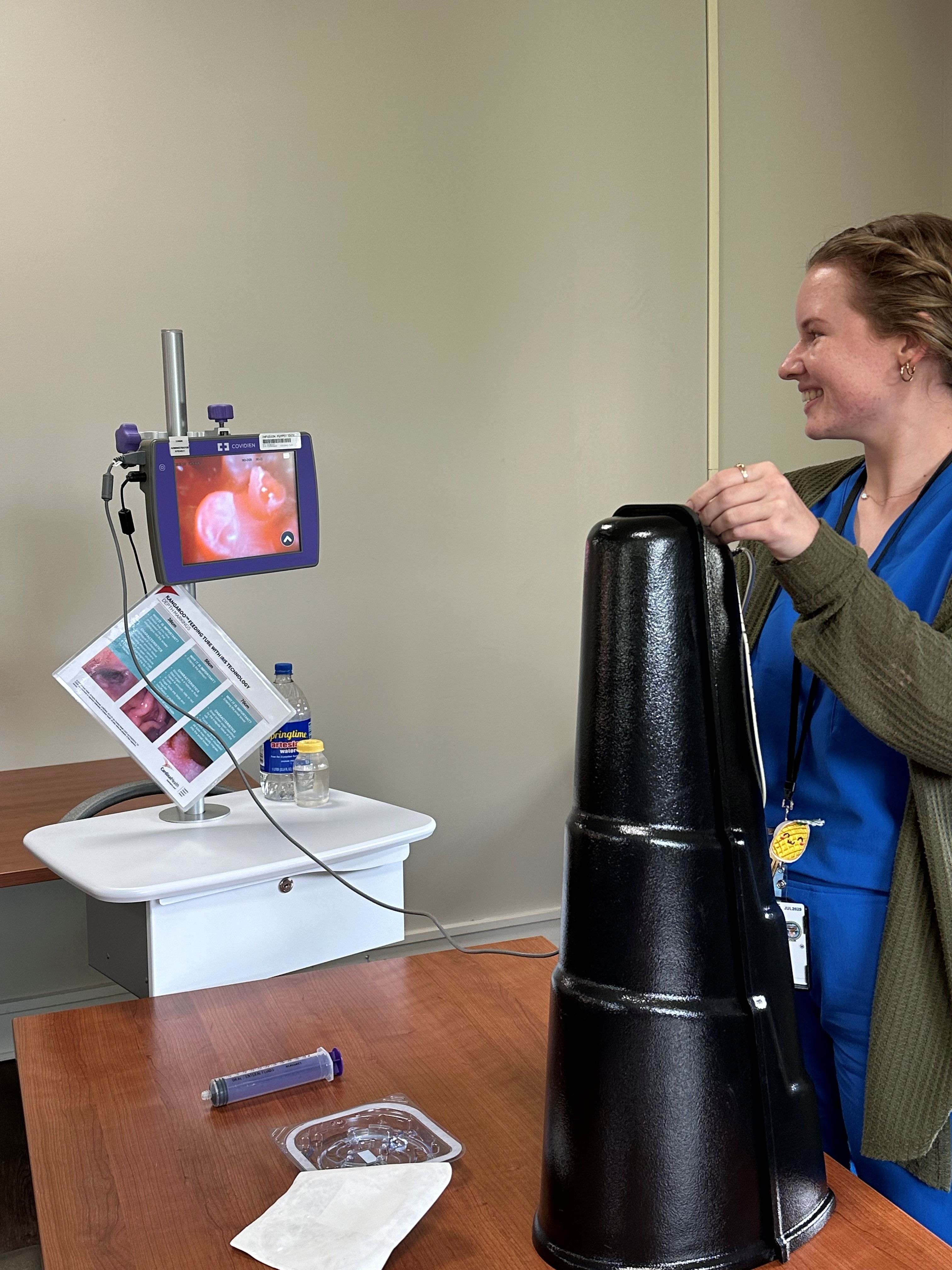 A student practicing the placement of a feeding tube